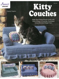 a cat sitting on top of a blue couch in front of a fire place with knitted cushions