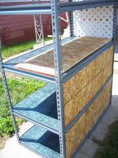 a metal shelving unit with three shelves and one shelf filled with wood planks