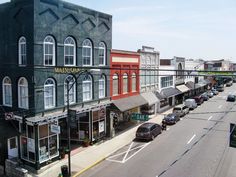 an empty city street with cars parked on the side