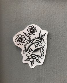 a sticker that says we amo with flowers on it