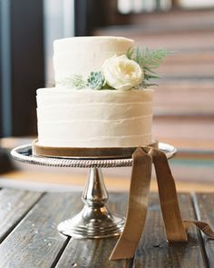 a wedding cake sitting on top of a wooden table