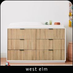 an image of a dresser with drawers in the middle and text west elm on it