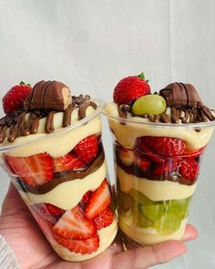 two dessert cups filled with fruit and chocolate