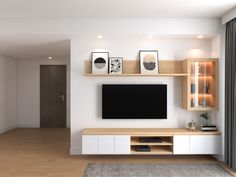 a modern living room with white walls and wood flooring, built - in entertainment center