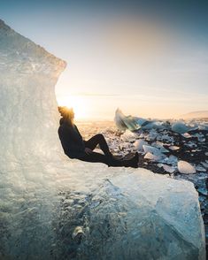 a person sitting on top of an iceberg