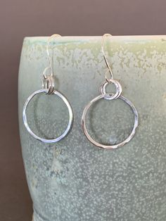 "Hand Forged Metal Jewelry | Silver Hoop Earrings, Fine Sterling Silver These round hoop earrings are perfect for everyday wear and would make a wonderful gift. We use only fine and sterling silver for all of our jewelry and findings, including our handmade earwires. Shaped and hammered for simplicity and elegance; then tumbled for strength and durability. Size is approximately 7/8\" x 1 7/8\". Our designs are each individually handcrafted and made to order.. because of this each design may have Hypoallergenic Sterling Silver Open Circle Earrings, Hypoallergenic Open Circle Sterling Silver Earrings, Nickel-free Sterling Silver Open Circle Earrings, Sterling Silver Open Circle Hoop Earrings For Pierced Ears, Sterling Silver Open Circle Hoop Earrings, Everyday Sterling Silver Hoop Earrings, Silver Single Open Circle Earring, Single Silver Open Circle Earring, Everyday Open Circle Earrings With Ear Wire