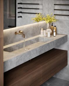 a bathroom sink sitting under a mirror next to a counter top with soap dispensers on it