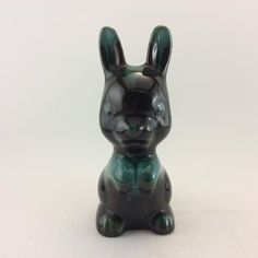 a ceramic rabbit figurine sitting on top of a table