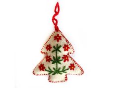 a christmas tree ornament hanging from a red string on a white background with flowers