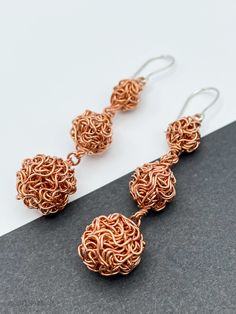 "DON 925's master silversmiths handcrafted these beautiful dangle earrings with copper and sterling silver. The soldering and hook are made of solid 925 sterling silver. Each cluster ball is handmade of copper wire (truly unique!). Length: 6.6 cm (2.60\") Largest ball size: 13 mm (0.50\") Pair weight: 12.7 g (0.44 oz) ★Premium DON925 bag included ★FAQs: https://www.etsy.com/shop/don925#faq ★GET 20% OFF IMMEDIATELY: https://mailchi.mp/998bd2af9c58/don925newsletter ★Instagram @don925newyork ★About Copper Wire Dangle Earrings As Gift, Copper Wire Drop Earrings With Matching Set, Artisan Copper Wire Drop Earrings, Handmade Copper Drop Earrings, Copper Wire Dangle Earrings, Artisan Rose Gold Sterling Silver Jewelry, Unique Rose Gold Dangle Jewelry, Unique Nickel-free Copper Wire Earrings, Elegant Copper Wire Drop Earrings