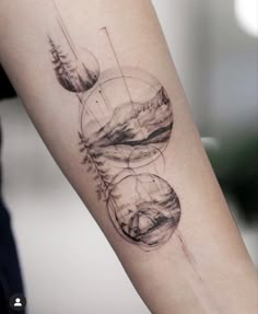 a woman's arm with an abstract tattoo on it