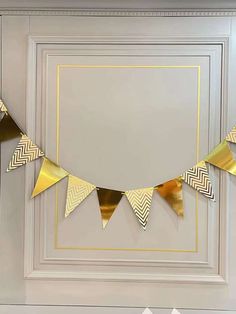 a gold and white party banner hanging on the wall