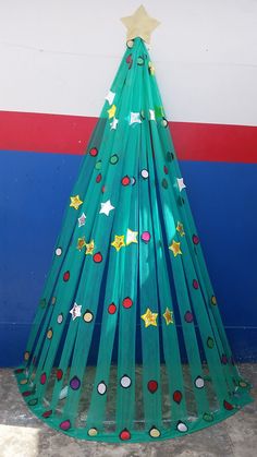 a christmas tree made out of plastic wrapped in green paper with stars and dots on it