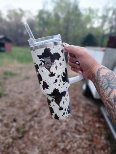 a person holding a cup with some paint on it