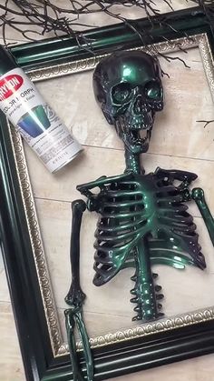 a green skeleton in a frame next to a paintbrush