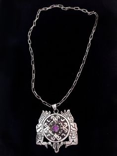 "Vintage Mexican pendant with amethyst, on a handmade chain, circa 1930s. The pendant measures 2 3/4\" long, 2 1/2\" wide, and has a design of two Aztec or Inca warrior figures on either side of a shield, with a small amethyst stone in the middle. Classic vintage Taxco design. It is on a 20\" long beautifully textured handmade chain with a hook clasp. The back of the pendant is marked \"Sterling\" and \"Hecho en Mexico\" with unknown initials. We ship with USPS, insured for the full value of the Collectible Amethyst Jewelry, Symbolic Purple Amethyst Jewelry, Unique Hand Forged Purple Necklaces, Symbolic Amethyst Purple Jewelry, Hand Forged Purple Pendant Necklace, Purple Amethyst Symbolic Jewelry, Aztec Necklace, Mexican Necklace Green, Hand-forged Purple Pendant Necklace