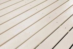 a close up view of a white wooden floor with lines on the top and bottom