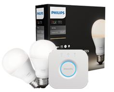 the philips smart light bulb is in front of its box and next to it's packaging