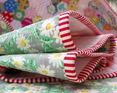 three pieces of fabric sitting on top of each other in front of a flowery background