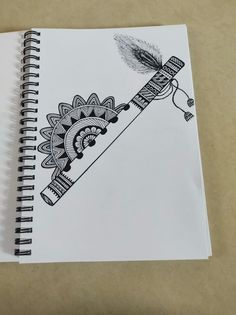 a spiral notebook with an image of a bird flying on top of a feathered object