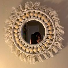 a woman taking a selfie in front of a mirror with balls hanging from it