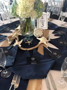 the centerpieces on this table are nautical themed