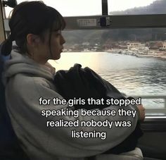 a woman sitting on a bus looking out the window