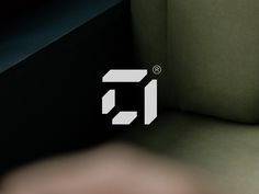 a close up of a person's hand on a couch with the letter f in white