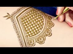 a woman is getting henna done on her arm with a pen and inking it