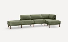 a green couch and footstool sitting next to each other