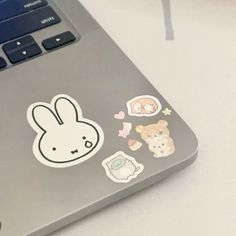 an open laptop computer sitting on top of a white table next to a mouse and keyboard