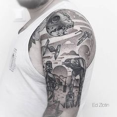 a man with a star wars tattoo on his arm and shoulder is shown in black and white