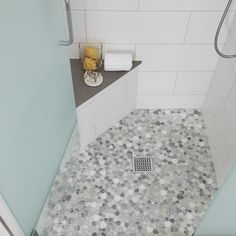 a bathroom with a shower, toilet and sink in it's corner stall that has coins on the floor