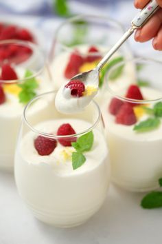 small desserts with raspberries and yogurt are being spooned out