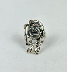 Vintage 925 Sterling Silver Elongated Stylized Floral Leafy Rose Vine Ring in Size 6.5 This beautiful, stylized 3D, Sterling Silver ring is shaped like a large ornate rose in full bloom surrounded by curling vines and leaves. The elongated, elegant shape extends from knuckle to knuckle. The Victorian style of the piece is perfect for all types of wardrobes from Princess to Gothic. The handcrafted rose design is affixed to a narrow band for comfortable fit. This is a truly classic vintage piece that is sure to make a statement! 925 Sterling Silver Marked on inside band: 925, ©️ SE Weighs approximately: 6.34 grams  Ring Top Length: (just under) 1 1/4" Ring Size: 6.5 US  Pre owned vintage jewelry in good condition. This item is as pictured. Please see photos and video slideshow for details. T 3d Ring, Stylized 3d, Rose Vine, Vine Ring, Rose Vines, Rose Design, Victorian Style, Classic Vintage, Victorian Fashion