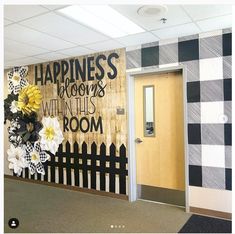 an office decorated with black and white checkered paper flowers, the words happiness is blooming within this room