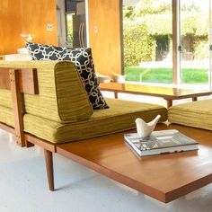 a living room with two couches and a coffee table in front of a sliding glass door