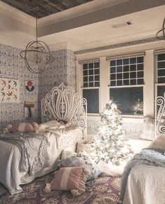 a bedroom with a christmas tree in the corner and other decorations on the wall behind it