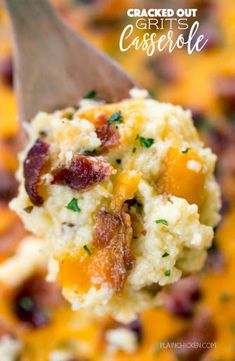 a spoon full of baked grits casserole with bacon and cheese on it