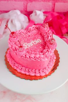 a pink heart shaped cake on a white plate