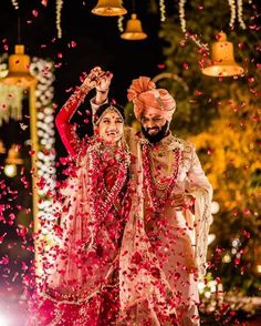 the bride and groom are walking through confetti