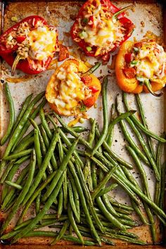 green beans and tomatoes on a baking sheet