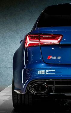 the rear end of a blue sports car