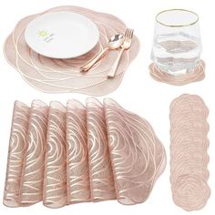 a set of pink place mats, napkins and silverware on a white background