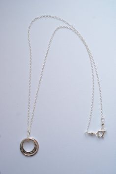 This lovely necklace will bring a simple style and elegance to any outfit. Three circles necklace, each circle is a different size. One circle is slightly large then the next. These circles are hand formed and then fused together. The smallest and middle sized circles are hammered to bring a shimmer to the charm - the largest of the three circles is a flat finish. Each circle is made from a heavy gauge fine silver (99.9% silver). The pendant measures about 1 inch. The necklace is a sterling silv Everyday Sterling Silver Round Charm Necklaces, Everyday Round Sterling Silver Charm Necklace, Classic Circular Sterling Silver Jewelry, Simple Silver Cable Chain Jewelry, Simple Silver Jewelry With Cable Chain, Round Charm Necklaces With Cable Chain For Anniversary, Silver Charm Necklace For Everyday, Delicate Silver Charm Necklaces, Round Charm Necklace With Cable Chain For Anniversary