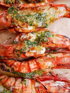 grilled lobsters with herbs and seasoning on them