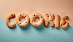 the word coors spelled out with cookies in front of a blue and pink background