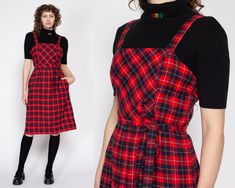 "Vintage 70s red & black plaid midi pinafore dress with a matching optional tie at the waist, and hip pockets. Shown modeled over a black top, not included with purchase. Measurements and Condition: Fits like: Labeled size 12, fits modern women's medium Fabric: Feels like wool - labeled dry clean only Brand: Route One Petite Miss, union made in USA Condition: Excellent Length: 41.5\" Chest: 37\" Waist: 28\" - cinches with tie Hips: 43\"  Shown on a 5'8\" model with measurements of 34\"-26\"-37\" Midi Pinafore Dress, Overall Jumper, Pinafore Dress, Vintage Belts, Red And Black Plaid, Dress Vintage, Jumper Dress, Black Plaid, Black Top