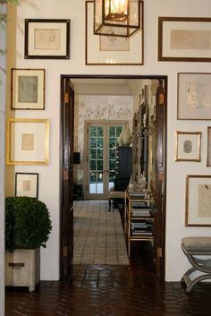 the hallway is decorated with many framed pictures