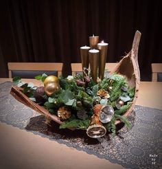 a wooden bowl filled with candles on top of a table